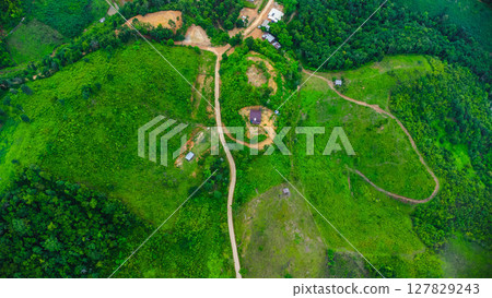 Rainy season landscape of a mountain village in the morning and mountains in the background. 127829243