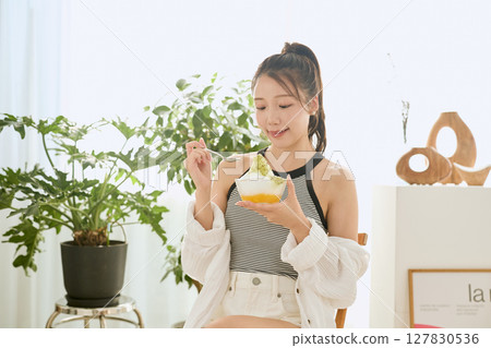 Summer refreshing young woman drinking lemonade in room Summer refreshing young woman drinking lemonade in room 127830536
