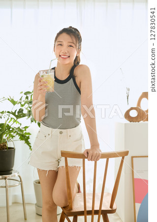 Summer refreshing young woman drinking lemonade in room Summer refreshing young woman drinking lemonade in room 127830541