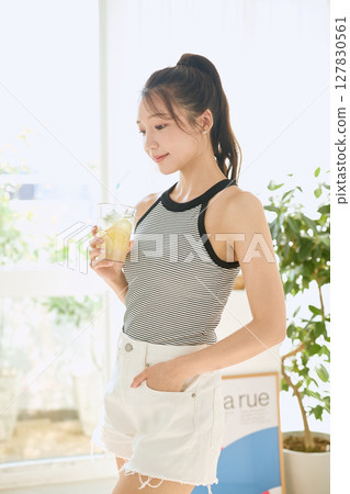 夏日清爽的年輕女子在房間裡喝檸檬水 127830561