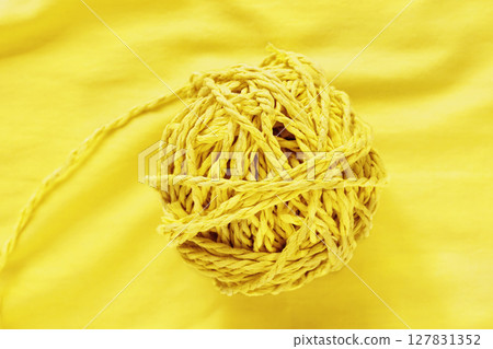 A ball of yellow twine A ball of yellow twine 127831352