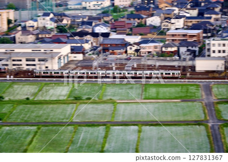 Meitetsu Seto Line running through the countryside at dusk Meitetsu Seto Line running through the countryside at dusk 127831367