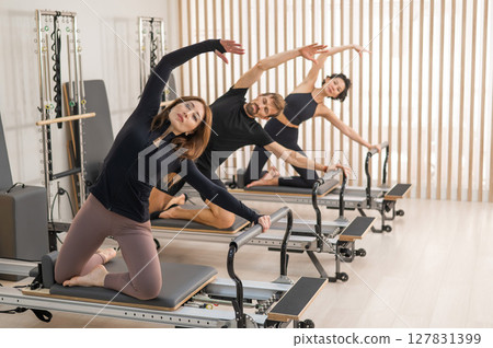 Engaging Group Pilates Session in a Modern Studio 127831399