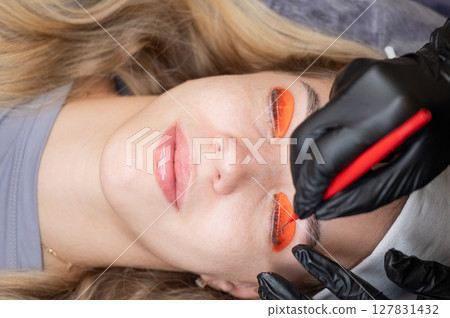 Caucasian woman undergoing eyelash lamination procedure. Caucasian woman undergoing eyelash lamination procedure. 127831432