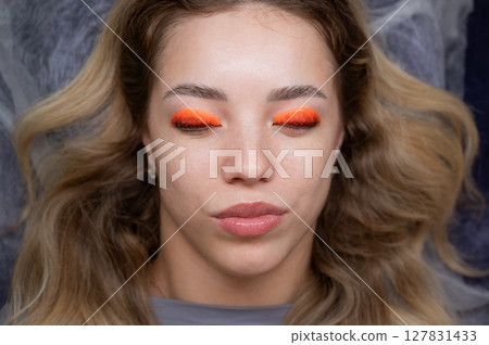 Caucasian woman undergoing eyelash lamination procedure. Top view.  127831433