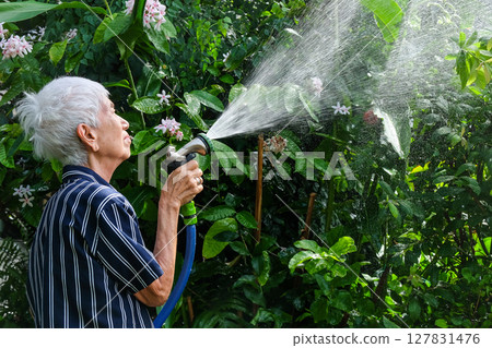 Senior asian woman watering the garden 127831476