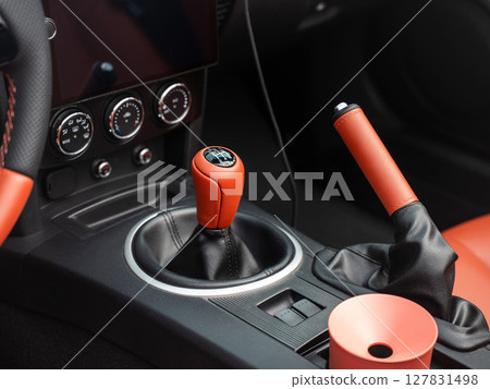 Detailed Close-Up of a Sports Car Gear Shift and Interior Features. Detailed Close-Up of a Sports Car Gear Shift and Interior Features. 127831498