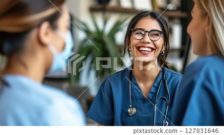 Hospital staff having fun chatting with each other during a break. A moment of camaraderie as hospital staff recharge with some lighthearted banter. Team spirit at its best! Hospital staff having fun chatting with each other during a break. A moment of camaraderie as hospital staff recharge with some lighthearted banter. Team spirit at its best! 127831646