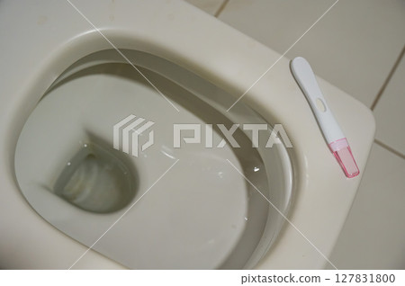 Pregnancy test on the toilet.  127831800