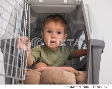 A small child in a closed cage. 127831878