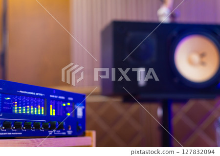 LED VU meter, audio meterbridge on loudspeaker monitor background in recording studio. music production, recording concept LED VU meter, audio meterbridge on loudspeaker monitor background in recording studio. music production, recording concept 127832094