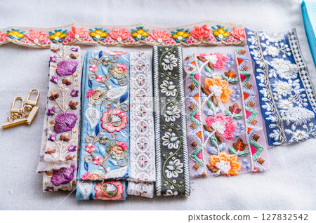 Indian embroidered ribbon and crimped end pieces 127832542