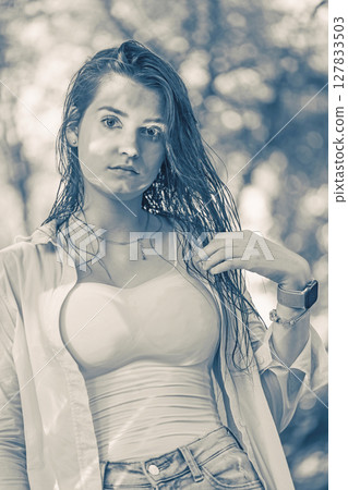 Monochrome portrait of a young slim  woman posing with wet hair . 127833503