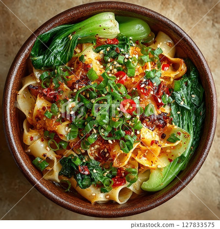 Vibrant Spicy Asian Noodle Soup A Delicious Bowl of Wide Noodles, Bok Choy, Chili Oil, and Fresh Scallions, Perfect for Culinary Themes 127833575