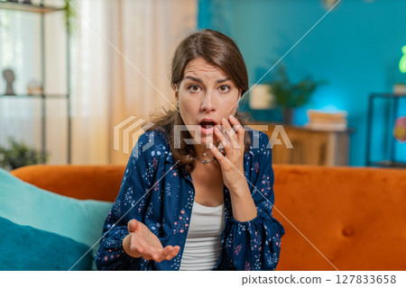 Portrait of upset Caucasian young woman making face, feeling bored, disappointed in result, bad news 127833658