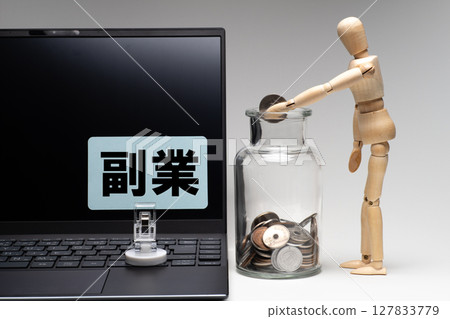 A drawing doll putting money into a jar with a laptop A drawing doll putting money into a jar with a laptop 127833779