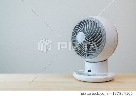 Air circulator placed on a desk Air circulator placed on a desk 127834165