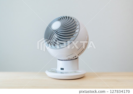 Air circulator placed on a desk 127834170
