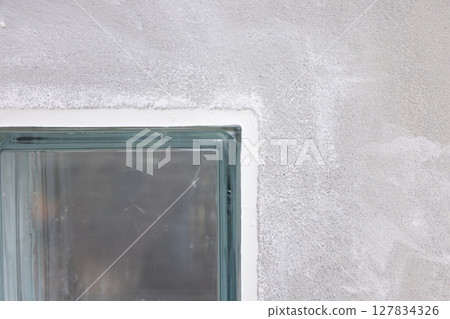 Clear glass block and concrete wall. Clear glass block and concrete wall. 127834326