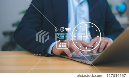 Businessman showing a 24-hour and 7-day icon, symbolizing 24/7 service, online payments, shopping, continuous transactions, and always-on cloud-based business operations for modern digital services. Businessman showing a 24-hour and 7-day icon, symbolizing 24/7 service, online payments, shopping, continuous transactions, and always-on cloud-based business operations for modern digital services. 127834367
