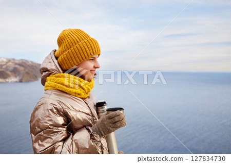 A young beautiful girl on a journey admires the beauty of nature. A young beautiful girl on a journey admires the beauty of nature. 127834730
