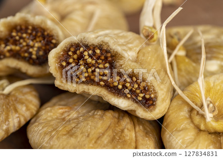 cut dried figs close up, light-colored figs with lots of seeds naturally dehydrated in the sun and cut into pieces 127834831