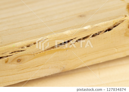 old wooden board with cracks, pine board cracked close up old wooden board with cracks, pine board cracked close up 127834874
