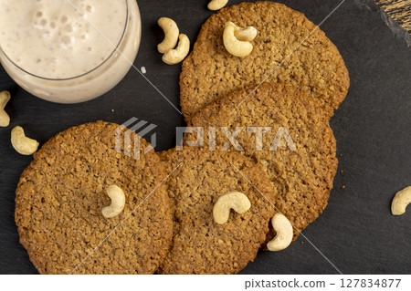 cookies and yogurt with prunes, a breakfast of oatmeal cookies and a glass of yogurt cookies and yogurt with prunes, a breakfast of oatmeal cookies and a glass of yogurt 127834877