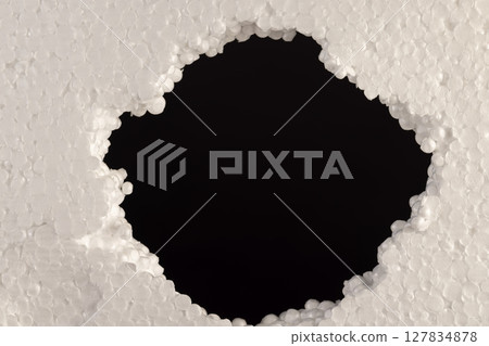 foam for building insulation, foam made from a large number of pieces joined together, a hole in the foam foam for building insulation, foam made from a large number of pieces joined together, a hole in the foam 127834878