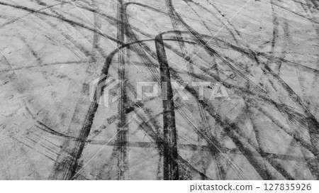 Aerial view car tire marks abstract street road background with black tire marks on race track, Texture and background car automobile and automotive skid tire marks. Aerial view car tire marks abstract street road background with black tire marks on race track, Texture and background car automobile and automotive skid tire marks. 127835926