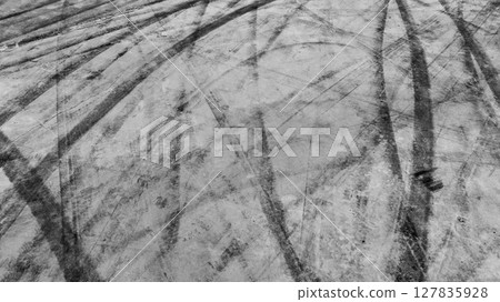 Aerial view car tire marks abstract street road background with black tire marks on race track, Texture and background car automobile and automotive skid tire marks. Aerial view car tire marks abstract street road background with black tire marks on race track, Texture and background car automobile and automotive skid tire marks. 127835928