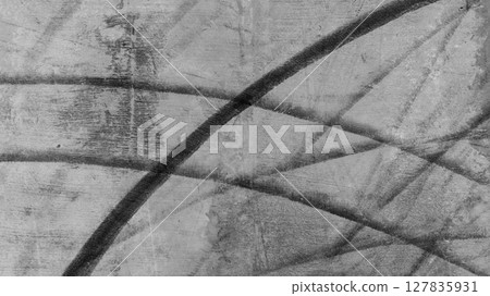 Aerial view car tire marks abstract street road background with black tire marks on race track, Texture and background car automobile and automotive skid tire marks. 127835931
