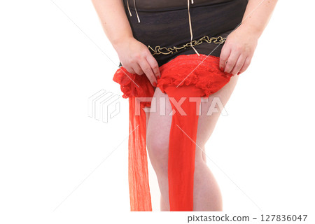 Woman plus size puts on red nylon stockings 127836047