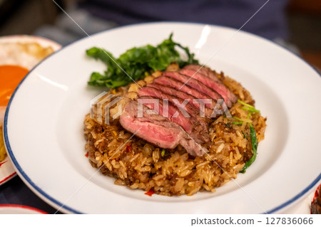 Stir-fried Basil with Rare beef steak served on plate. It is a popular Thai dish known as Pad Kra Pao 127836066