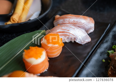 Salmon roll and salmon sushi served on plate Salmon roll and salmon sushi served on plate 127836078