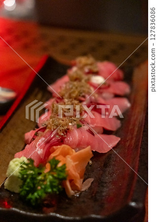 Tuna sushi with acebichado sauce, crispy shirou and salsa criolla. served on plate 127836086