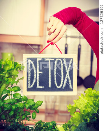 Woman having green diet vegetables, detox sign 127836192