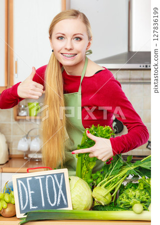 Woman having green diet vegetables, detox sign 127836199