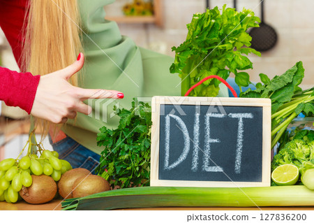 Kitchen table with many green diet vegetables 127836200