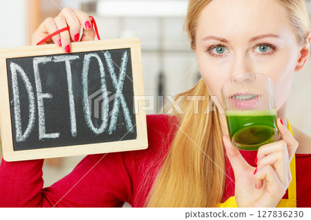 Woman holding vegetable juice and detox sign 127836230