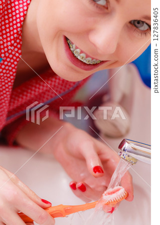 Woman brushing cleaning teeth in bathroom 127836405