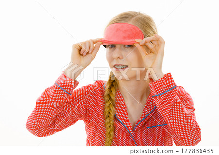 Sleepy woman wearing pink eye band Sleepy woman wearing pink eye band 127836435