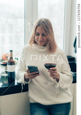 woman with wine and smartphone 127836708