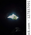 A view of the distant exit from the cave 127837091