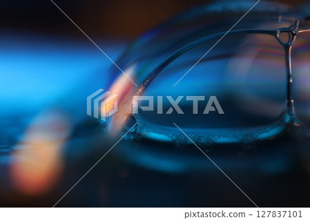 Blue liquid surface on black background, oil stains movement, bright chemistry, surreal background, blue sky colour, connection lines 127837101