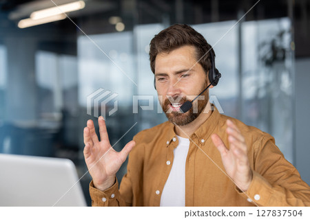 Mature business man in video conference call wearing headset, actively gesturing while talking. Engaging in remote communication, showcasing professional online interaction, work from home. Mature business man in video conference call wearing headset, actively gesturing while talking. Engaging in remote communication, showcasing professional online interaction, work from home. 127837504