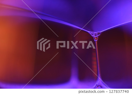 Purple and orange liquid abstraction, phenomenal water forms, dark background 127837740