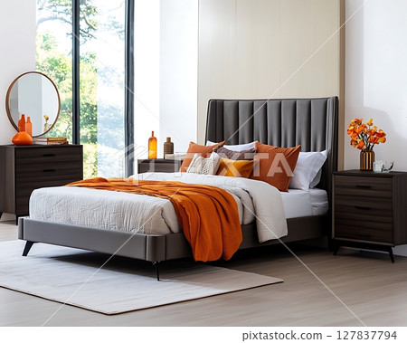 A bed with a grey headboard and a white comforter A bed with a grey headboard and a white comforter 127837794