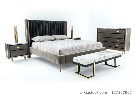 A bed with a black headboard and a white pillow sits in front of a white dresser 127837995
