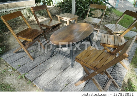 Wooden patio set with a round table and four chairs 127838031
